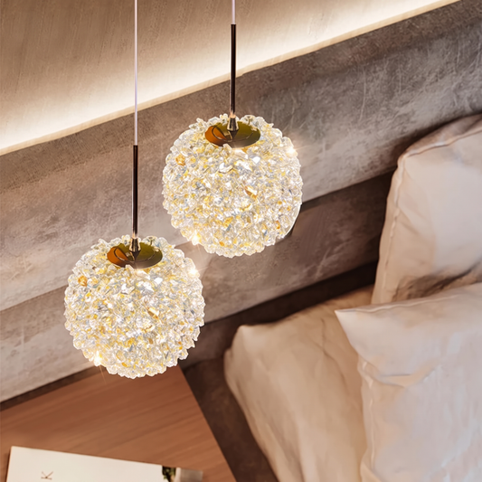 Double 15cm crystal ball pendant light beside a bed
